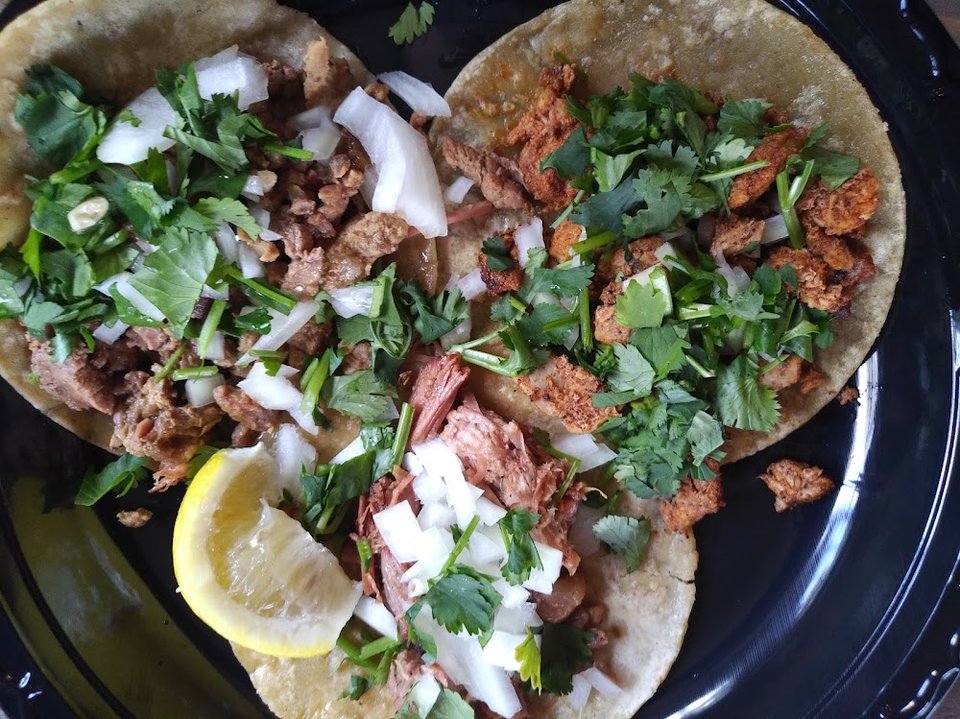 Printed menu with burritos, tacos, and plates.