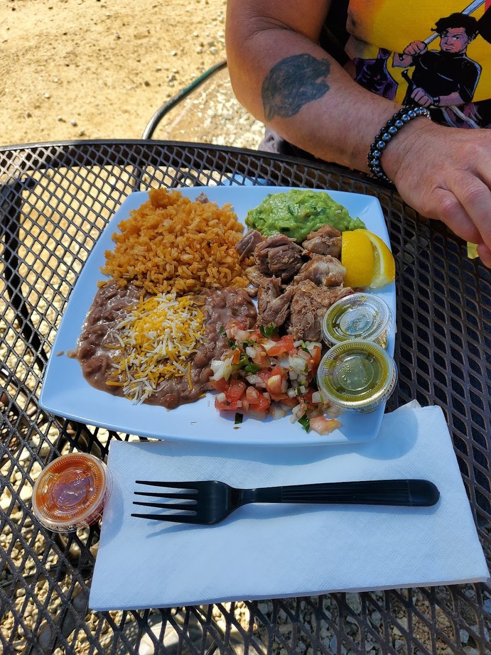 Printed menu with burritos, tacos, and plates.